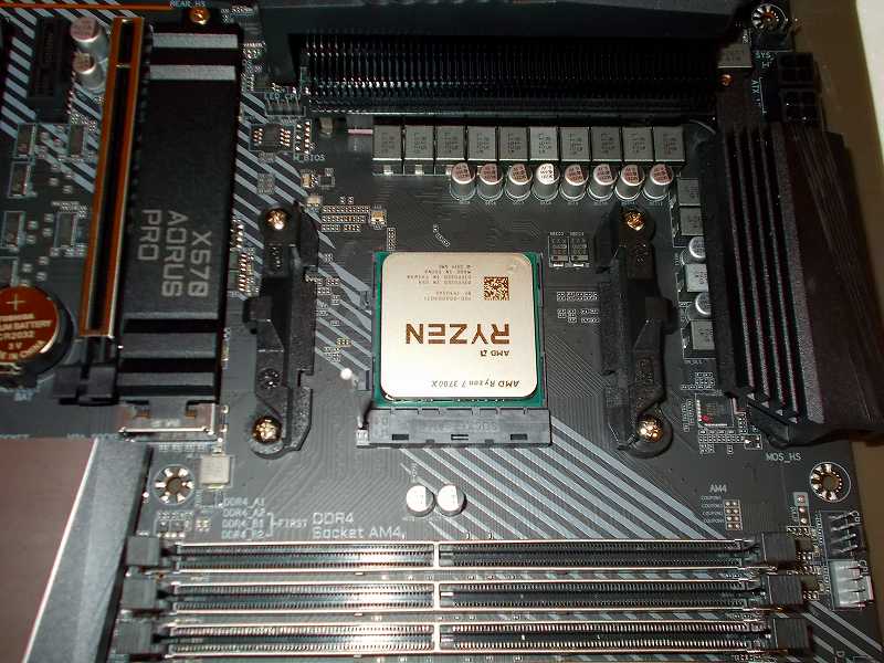 第 3 世代 Ryzen CPU（Zen 2）でこだわりの自作 PC を仮組！テストベンチ動作確認編、マザーボード GIGABYTE X570 AORUS PRO rev.1.0 に CPU AMD Ryzen 7 3700X 装着、マザーボード GIGABYTE X570 AORUS PRO rev.1.0 AM4 CPU ソケットのレバーを上げて CPU AMD Ryzen 7 3700X 装着